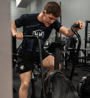 Athlete doing intense workout with a front view of the Heavy Handed Assassin Rashguard 
