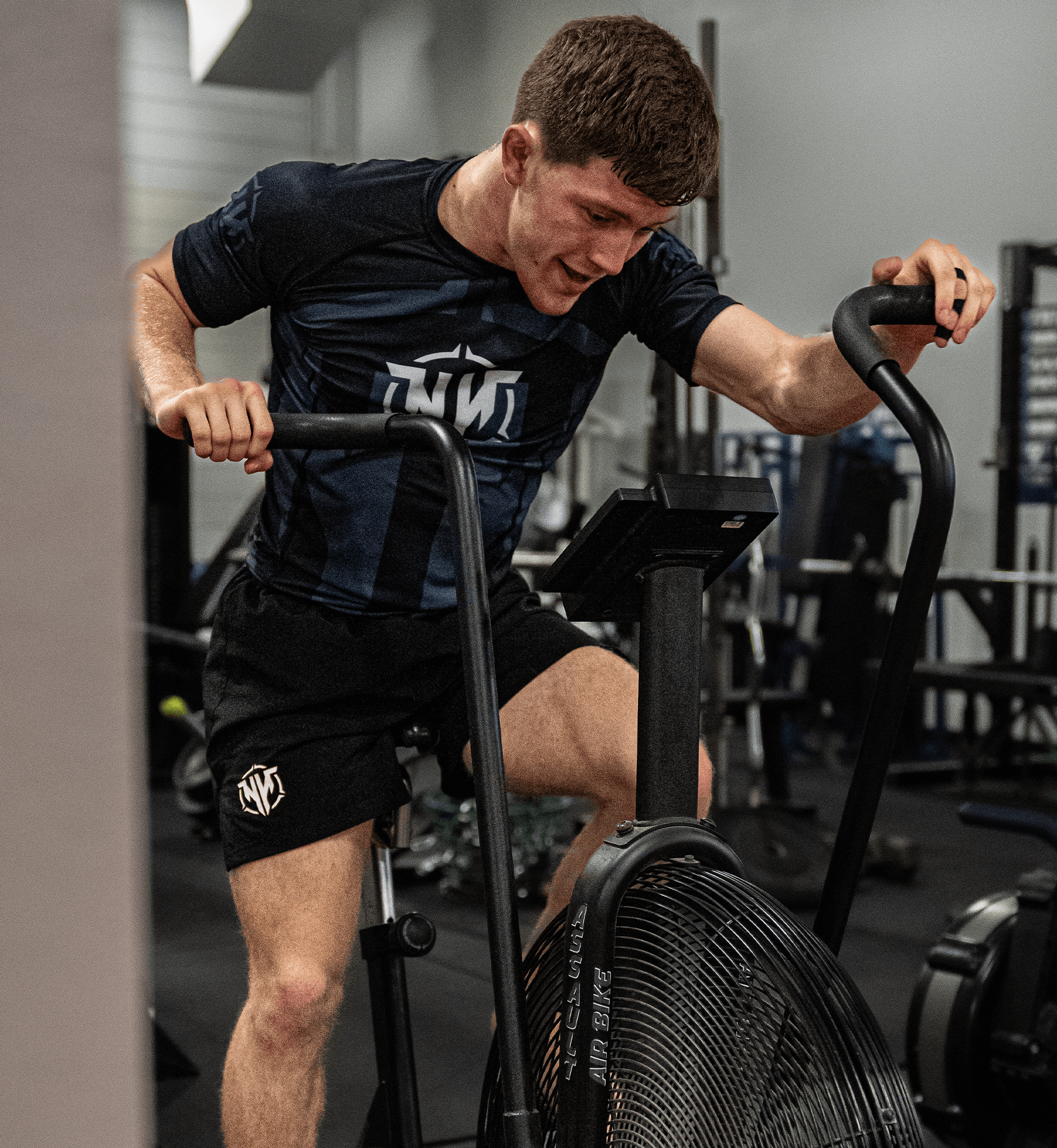 Athlete doing intense workout with a front view of the Heavy Handed Assassin Rashguard 